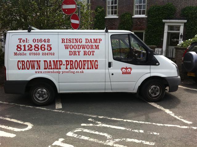 A Crown Damp-Proofing van signwritten with Rising Damp, Woodworm, Dry Rot and the office number